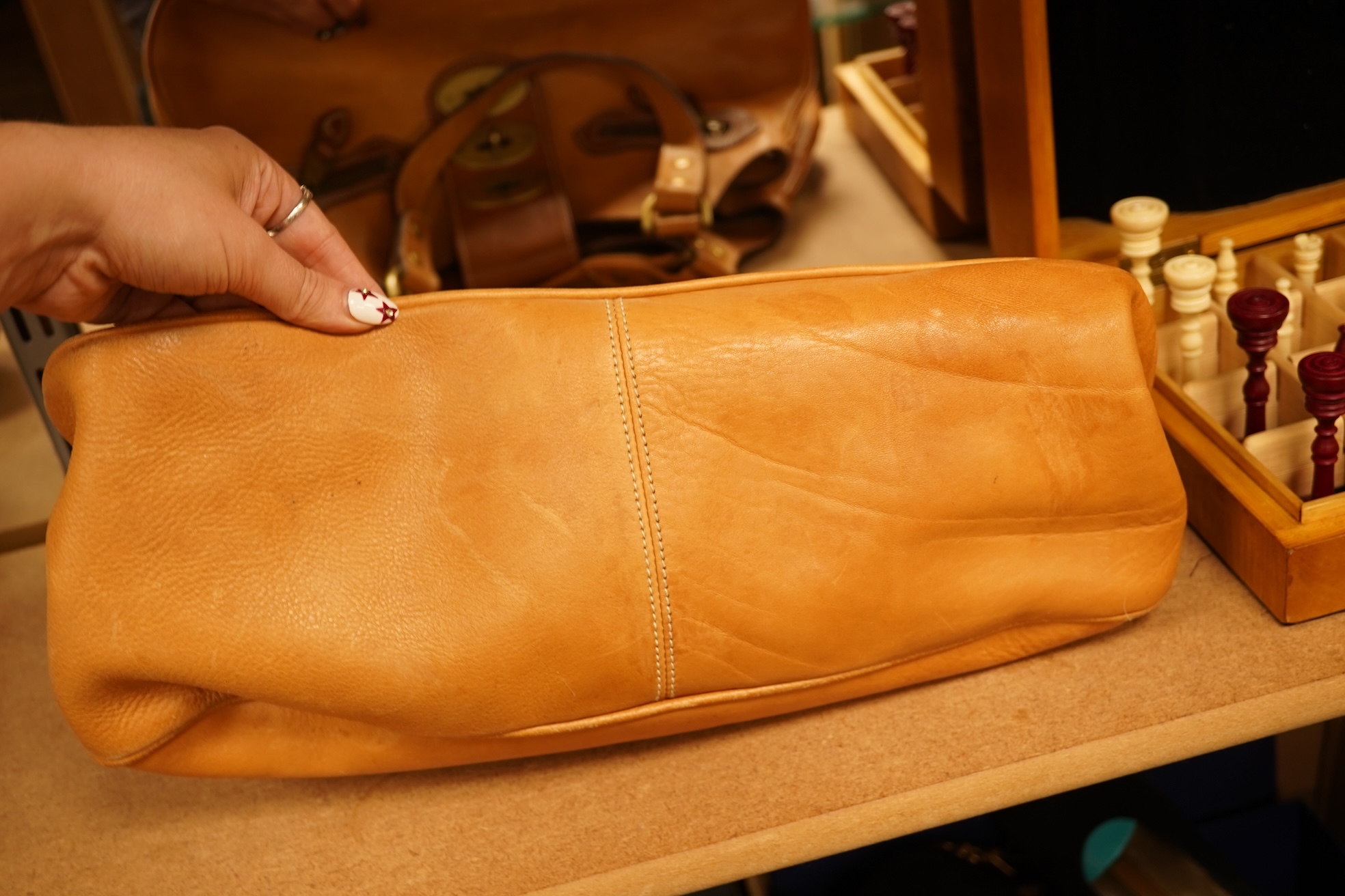 A Mulberry tote two zip, three postman clasps,tan leather with dark brown trim.handbag